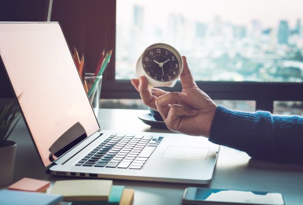 Computer with a clock on it 